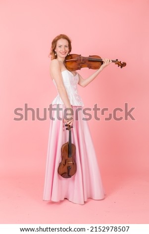 studio portrait of a girl with a violin and viola