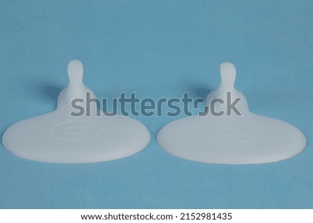Macro detail shot abstract pastel background image made of different compositions on blue backdrop of silicone medical foot healthcare products buy now. 