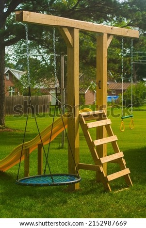 swingset playground diy in backyard play fun for kids outdoors Royalty-Free Stock Photo #2152987669