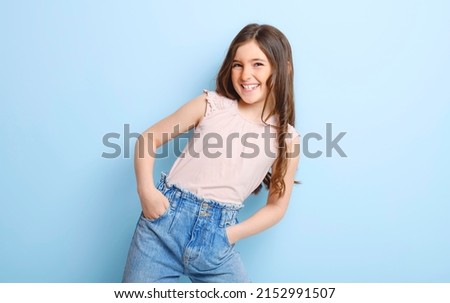 A cute child over blue background on studio