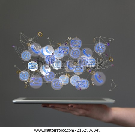 A close-up of approved email and spam message icons hovering over a tablet