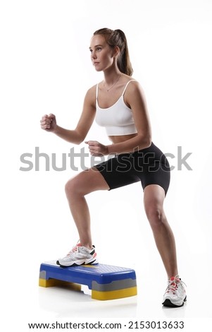 Fitness woman working out, studio shot.  Beautiful athletic girl on the white background