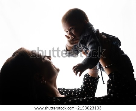 Silhouette of young family mom son. High quality photo