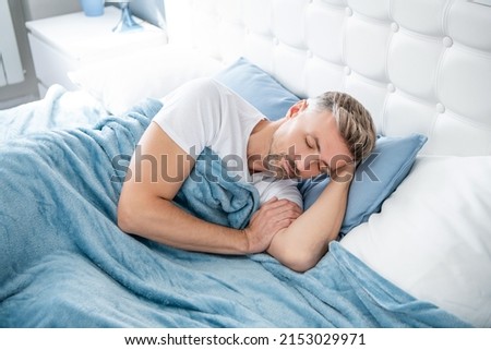 mature man sleeping in bedroom. early morning Royalty-Free Stock Photo #2153029971