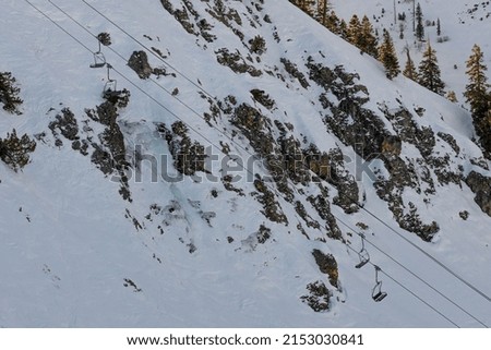 An aerial shot of the chairlifts at a ski resort in Sierra Nevada Mountains, California, United States