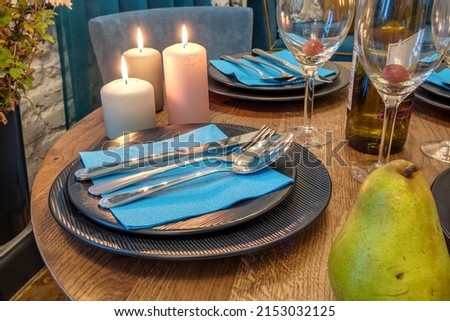 burning candles on a table with flowers with glasses or fruits, intimate romantic atmosphere Royalty-Free Stock Photo #2153032125