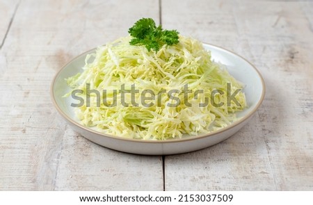 Sliced cabbage on the table. Green cabbage. Fresh vegetable. Prepared  salad. Benefits of cabbage. Healthy food.  Royalty-Free Stock Photo #2153037509