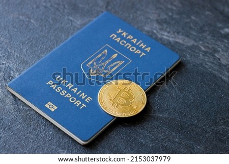 Urkainian passport with bitcoin golden coin. Urkaine currency during the war. Virtual money. Donation for Ukraine. Stop war.