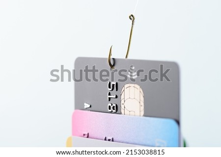 Credit card phishing scam concept. Credit card data theft, card hooked by hacker cyber criminal on fishing hook. Royalty-Free Stock Photo #2153038815