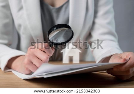 Customer studying real estate purchase, lease, loan or mortgage agreement. Woman hands with magnifying glass closeup. Contract legality and transparency. Moving into new home. High quality photo