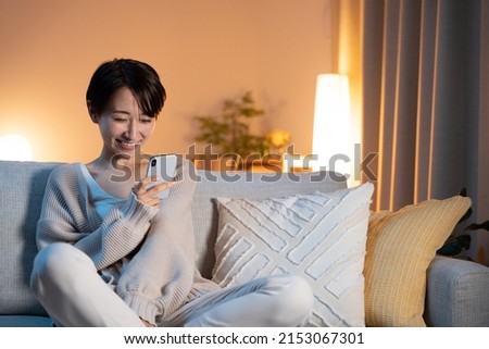 Woman relaxing at home at night