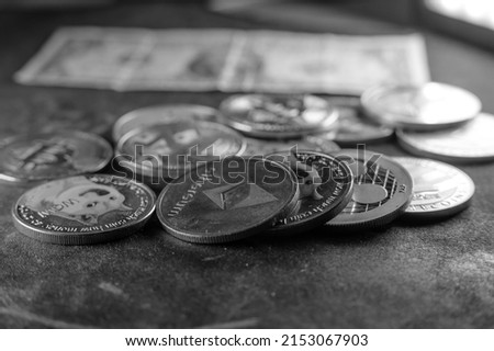 Crypto currency background with various of shiny silver and golden physical cryptocurrencies symbol coins, Bitcoin, Ethereum, Litecoin, zcash, ripple. Black and white style photo.