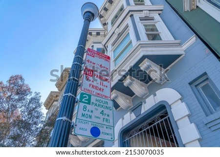 Street parking signs stacked on a street lamp post at San Francisco, California