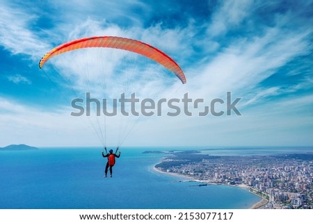 Paraglider is starting. Parachute is filling with air in the mountains alps on a sunny day in albania Royalty-Free Stock Photo #2153077117