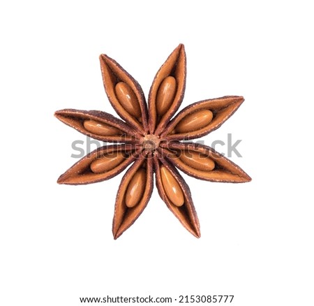 Dry star anise with seeds on a white background in a spoon. Close-up macro shot of star anise spices. Royalty-Free Stock Photo #2153085777