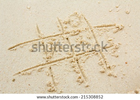 X and O game on the sand 