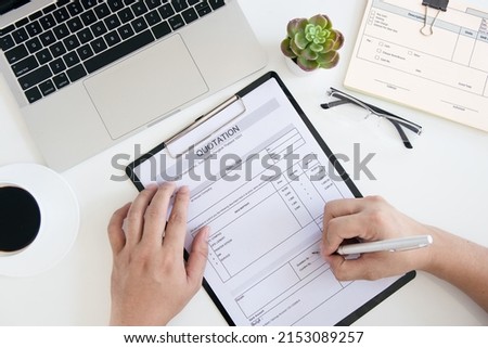 Business man signing document with pen makes signature sitting at his desk. Top View