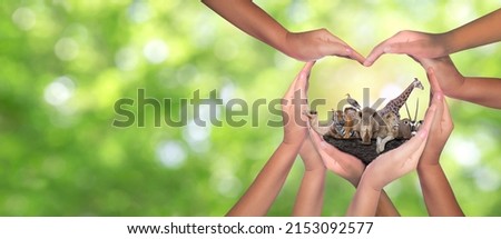 Wildlife Conservation Day. Or wildlife protection It's a diverse group of people who come together to build hands, hearts that connect to protect the environment. and promote conservation wildlife. Royalty-Free Stock Photo #2153092577
