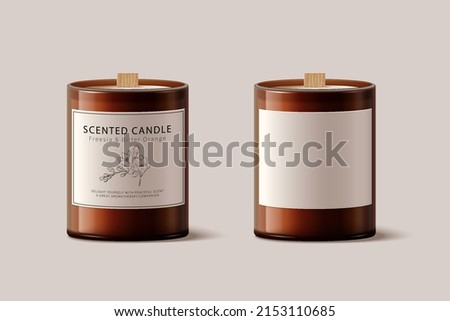 3d scented candle set, isolated on beige background. Brown glass product package, one with and without label design. Royalty-Free Stock Photo #2153110685