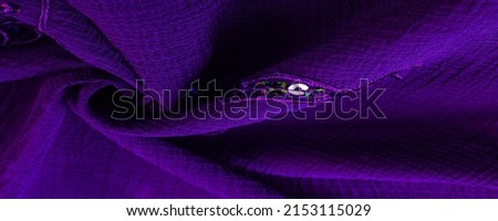 Silk blue. The fabric is embellished with sequins. background, silk satin, luxurious texture, dark fabric, costume cotton material, abstract color image pattern, delicate liquid sapphire velvet