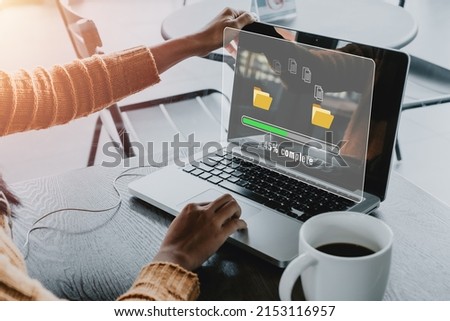 Transfer files data system relocation concept, Person hand using laptop computer waiting for transfer file process with loading bar icon on virtual screen.	

 Royalty-Free Stock Photo #2153116957