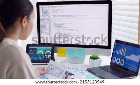 Asia young business woman sit busy at home office desk work code on desktop reskill upskill for job career remote self test IT deep tech ai design skill online html text for cyber security workforce. Royalty-Free Stock Photo #2153120549