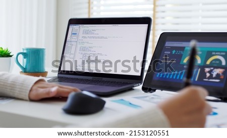 Back rear view of young asian woman, freelance data scientist work remotely at home coding programing on Big data mining, AI data engineering, IT Technician Works on Artificial Intelligence Project. Royalty-Free Stock Photo #2153120551