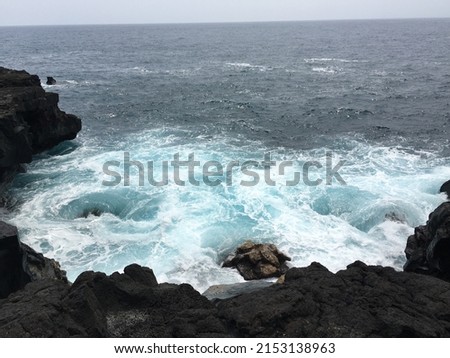 Several pictures of waves crashing against the lava rock on the big island of Hawaii.