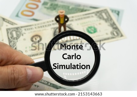 Monte Carlo Simulation.Magnifying glass showing the words.Background of banknotes and coins.basic concepts of finance.Business theme.Financial terms. Royalty-Free Stock Photo #2153143663