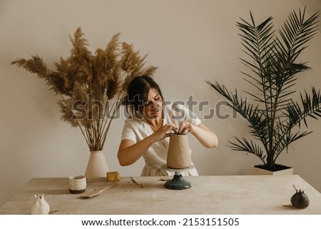Female ceramist hands sculpt clay dishes