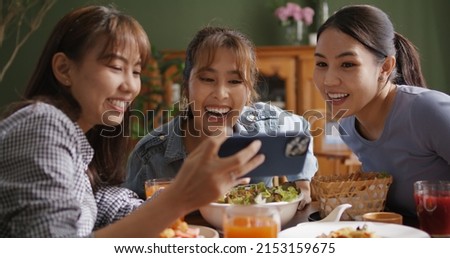 Asia teen girl vlogger group look camera VoIP talk on reel   app filming shoot live share vlog Gen Z youth people enjoy food dinner lunch at reopen cafe with fun joy party laugh relax smile Royalty-Free Stock Photo #2153159675