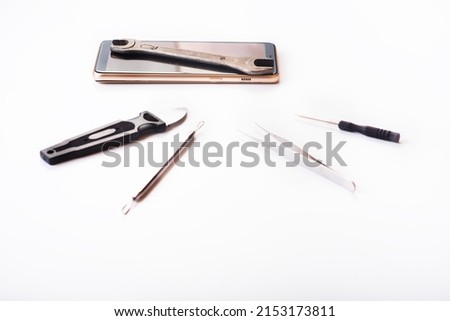 Flat lay image of dismantling the broken smart phone for preparing to repair or replace some components on the white background. repairing a damaged mobile phone. isolated. Top view