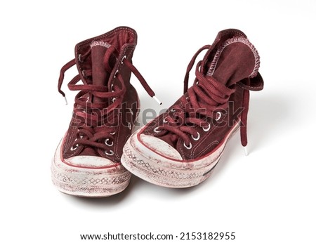 Old canvas shoes on white background