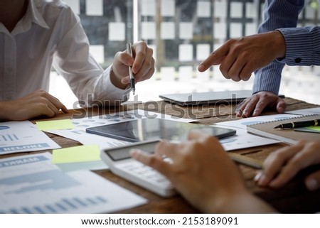 Financial analysts analyze business financial reports on a digital tablet planning investment project during a discussion at a meeting of corporate showing the results of their successful teamwork. Royalty-Free Stock Photo #2153189091