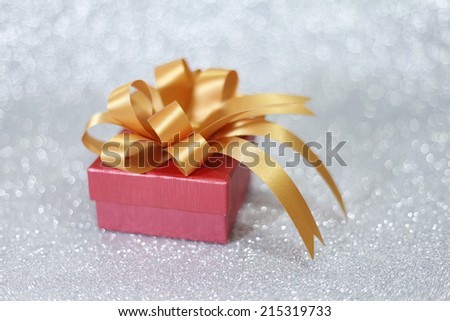 Christmas gift on Decorative background in silver.