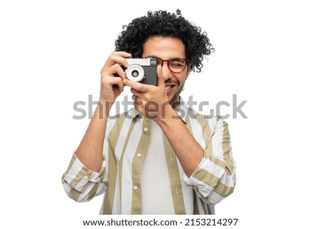 photography, profession and people and concept - happy smiling man or photographer in glasses with film camera over white background