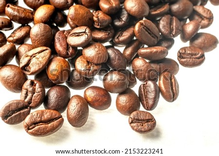 Close-up photo of coffee beans on a white background.shallow focus effect. soft focus.