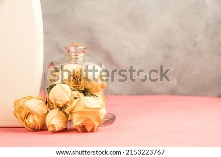 Dry buds of yellow roses on table. Symbol for floristry and perfumery. Romantic theme with free space for text. Preservation of freshly cut flowers for sale