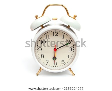 Classic white alarm clock with golden trim isolated on white background
