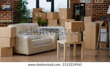 No people in empty living room apartment with carton boxes on stack, moving cardboard storage packaging in new household. Nobody in relocation property with interior furniture cargo. Royalty-Free Stock Photo #2153224965
