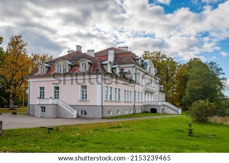 Sunny autumn weather drew tourists and visitors to enjoy the beautiful  Art Nouveau style house. Laupa manor, Estonia. Main building now houses a school. Royalty-Free Stock Photo #2153239465