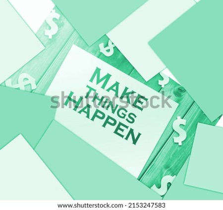 make things happen words on page and paper dollar signs around on wooden table. Financial business concept.
