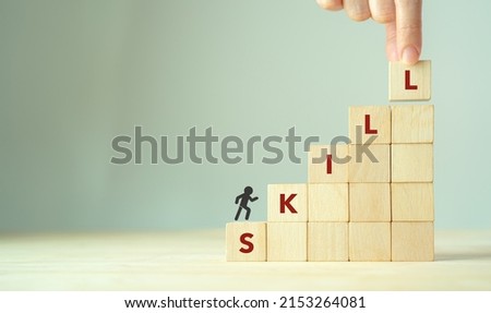 Upskilling and personal development concept. Skill training, education, learning, ability, knowledge and competency  for digital transformantion. Upskilling, reskilling, new skills icon on wooden cube Royalty-Free Stock Photo #2153264081