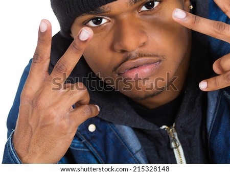 Closeup portrait, headshot trendy young man, student holding up peace, victory sign , isolated white background. Human emotions, facial expressions, symbols, attitude, non verbal communication.