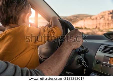 father teaching his little son to drive. playing driver in daddy's car. Father's day. parenting concept	
 Royalty-Free Stock Photo #2153282019