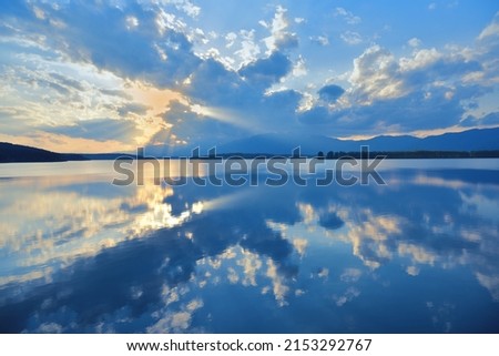 Beautiful Nature Background.Amazing Colorful Clouds.Water Reflections.Magic Artistic Wallpaper.Creative Photography.Blue Sky and Sunset.Mountain Landscape.Tranquil Panorama.Sun and Lake.Blue Color. Royalty-Free Stock Photo #2153292767