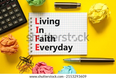 LIFE living in faith everyday symbol. Concept words LIFE living in faith everyday on note on beautiful yellow background. Black calculator. Business LIFE living in faith everyday concept. Copy space.