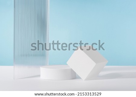 Acrylic ribbed plate, podium, background for cosmetic product packaging on blue backdrop. Showcase for jewellery presentation, display for perfume advertising, cosmetics branding scene mockup
