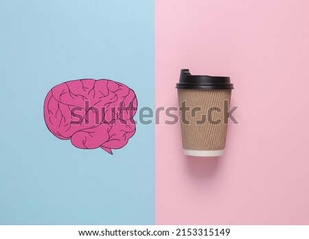 Paper-cut brain and a cup of coffee on a pink background. Charge up your brain. Flat lay