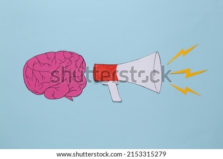 Paper cut cartoon brain with megaphone on blue background